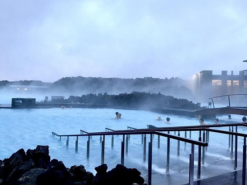 Milky geothermal water and black lava at the Blue Lagoon at dusk