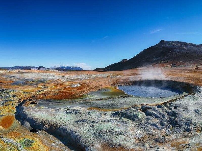 Steam rising off a mineral-crusted geothermal pool on the Reykjanes peninsula